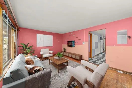 a living room with furniture and wooden floor