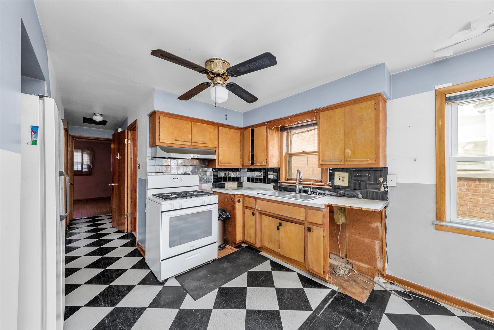 2044 West 69th Street Chicago, IL 60636 - Photo 8 of 27 a kitchen with granite countertop stainless steel appliances a stove a sink and a window
