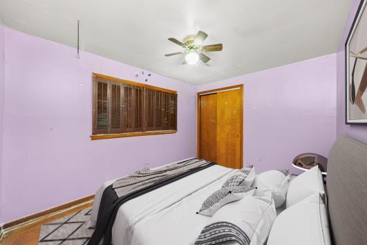 2044 West 69th Street Chicago, IL 60636 - Photo 9 of 27 a bedroom with a bed and a window