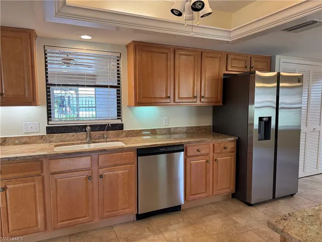 a spacious bathroom with a granite countertop sink toilet a large mirror and a shower