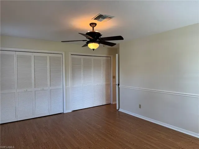 a view of a patio with table and chairs under an umbrella