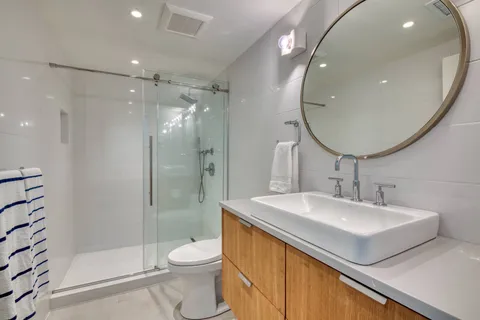 a bathroom with a sink toilet and shower