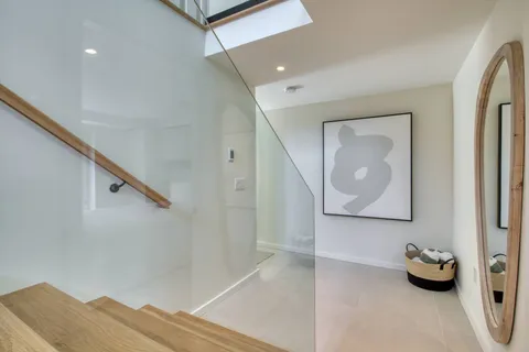a hallway with wooden floor and furniture