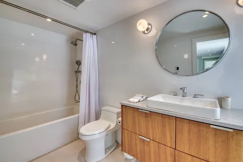 a bathroom with a sink toilet and shower