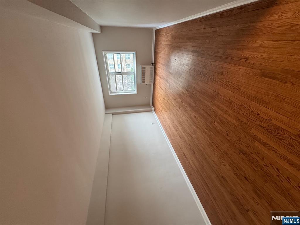 a view of an empty room and wooden floor