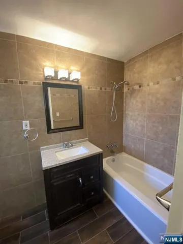 a bathroom with a sink a mirror and a bathtub