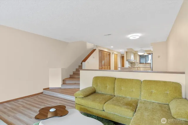 a living room with furniture and wooden floor