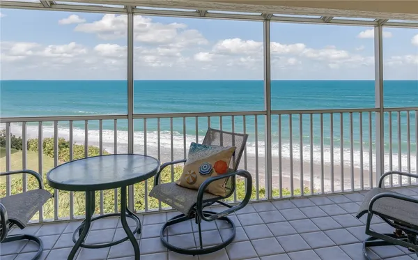a view of a balcony with furniture