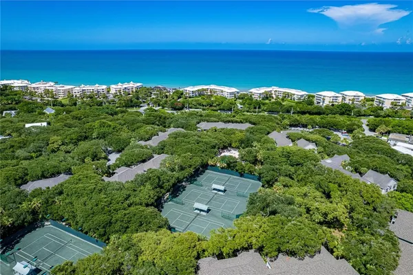 an aerial view of a houses with a yard