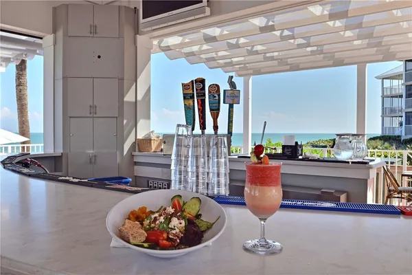 a living room with fireplace furniture and a potted plant