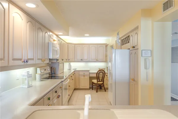 a kitchen with a refrigerator and a sink