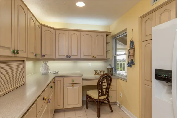 a kitchen with a sink cabinets and wooden floor