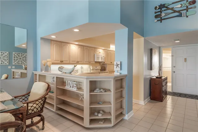 a open kitchen with stainless steel appliances granite countertop a stove and a refrigerator