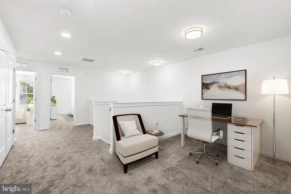 a living room with furniture a desk and workspace