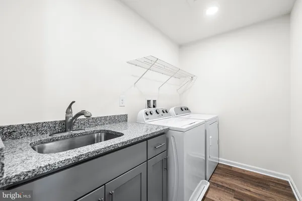 a utility room with sink and dryer