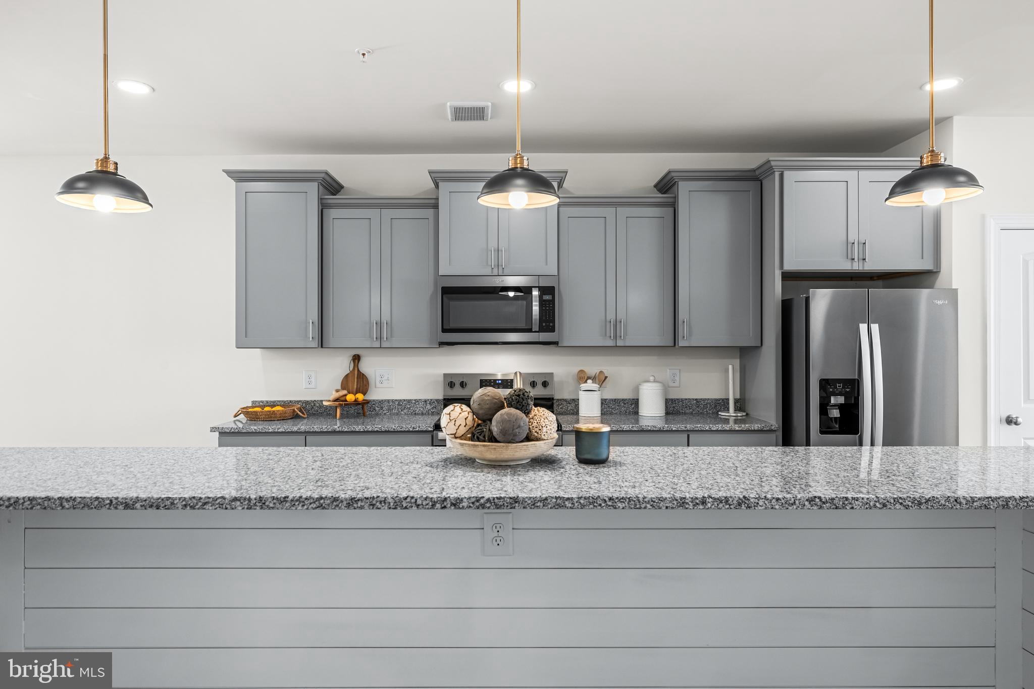 900 Gilbert Road, Unit 3618A Aberdeen, MD 21001 - Photo 8 of 23 a kitchen with granite countertop a sink cabinets and stainless steel appliances