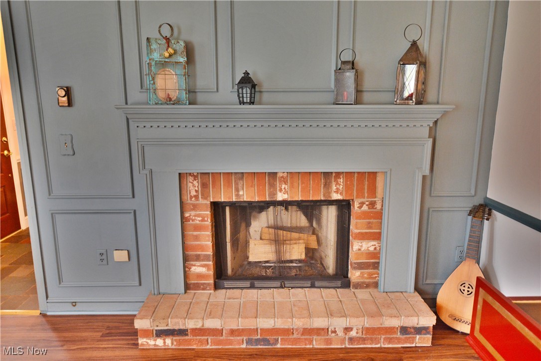 16140 Thompson Road Thompson, OH 44086 - Photo 34 of 50 Detailed view of a brick fireplace and wood finished floors