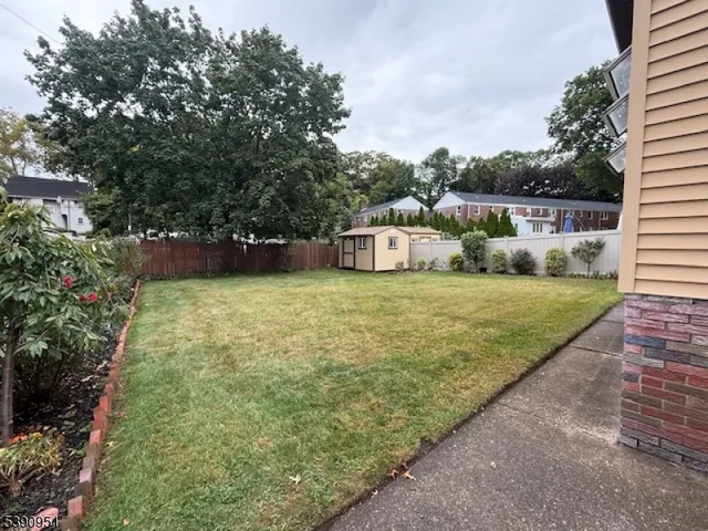 a view of a backyard with plants and lake view