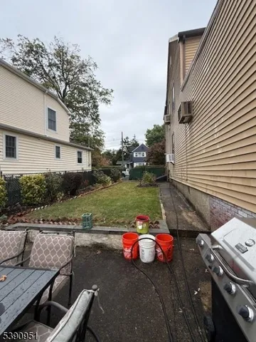 a view of an outdoor sitting area with furniture and lake view
