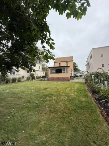 a view of a back yard of the house with a lake view