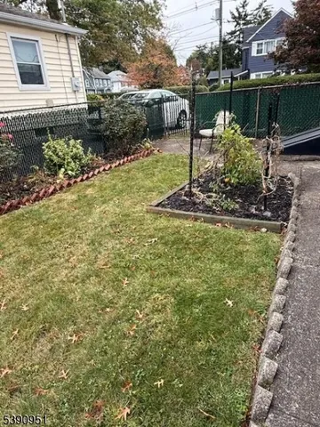 a view of a garden with large trees