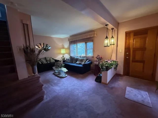 a living room with furniture potted plant and a window