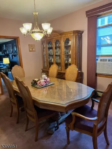 a view of a dining room with furniture and chandelier