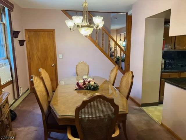 a view of a dining room with furniture and a chandelier