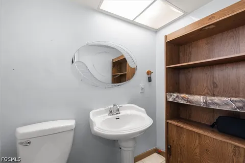 a bathroom with a sink a mirror and toilet