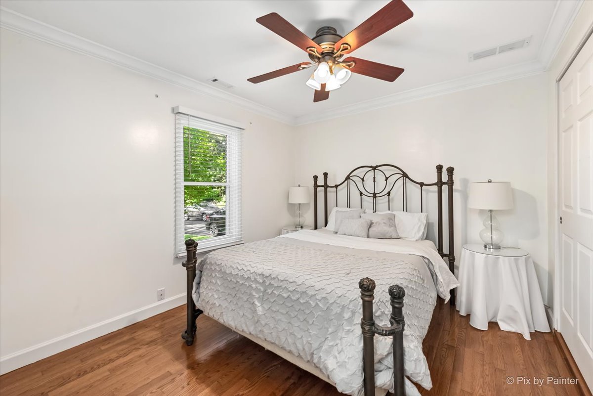 116 Deerpath Road Lake In The Hills, IL 60156 - Photo 14 of 33 a bedroom with a bed and a chandelier