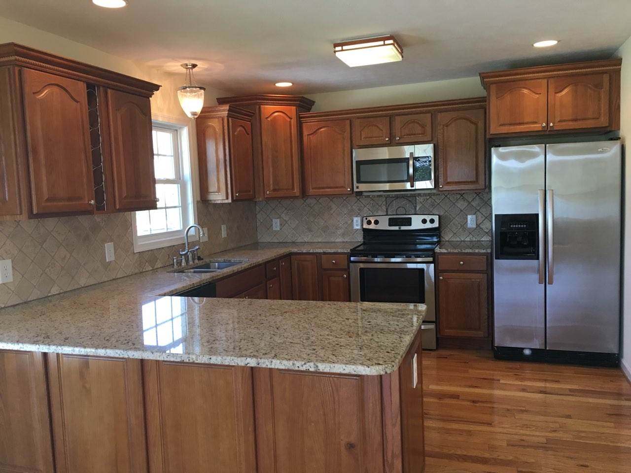 32 Fox Crest Ridge Staunton, VA 24401 - Photo 4 of 32 a kitchen with stainless steel appliances granite countertop a sink a stove and a refrigerator