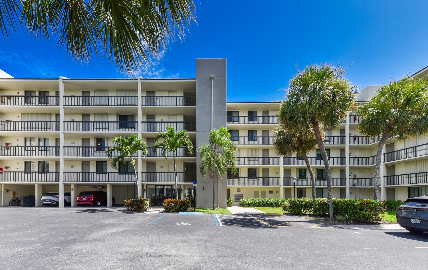 1605 Highway 1, Unit M1403 Jupiter, FL 33477 - Photo 1 of 34 a front view of a building with a garden and plants