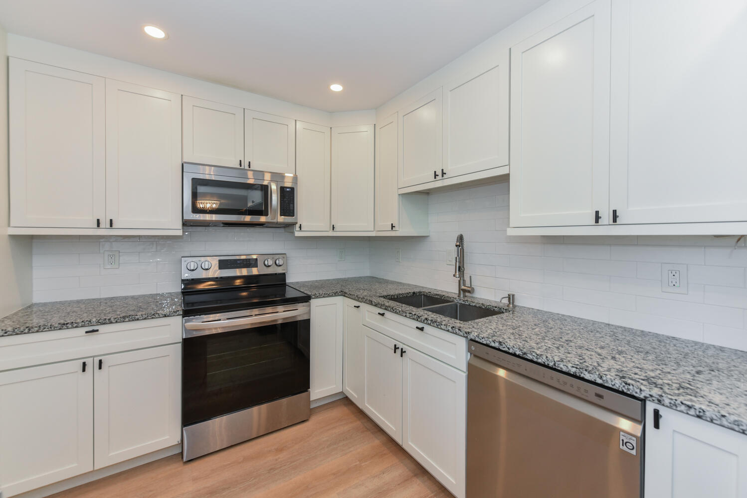 1605 Highway 1, Unit M1403 Jupiter, FL 33477 - Photo 12 of 34 a kitchen with stainless steel appliances granite countertop white cabinets granite counter tops and a hard wood floors