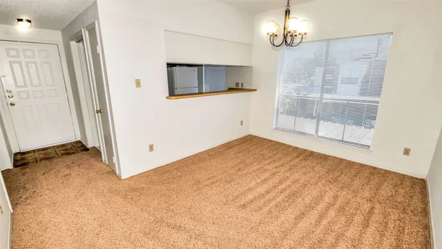 en empty room with wooden floor and windows