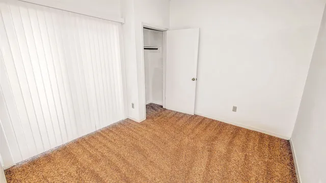 a view of a bedroom with a wooden wall