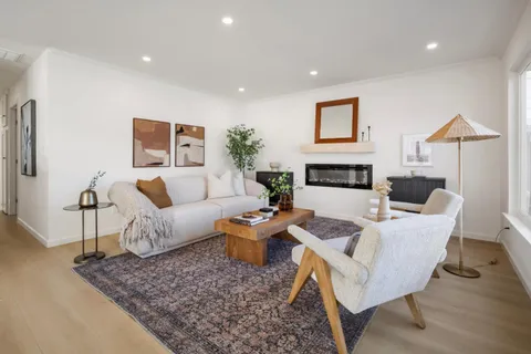 a view of a hallway with wooden floor and cabinet