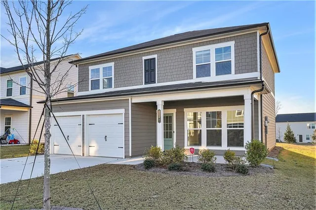 a front view of a house with a yard