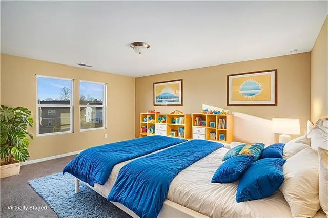 a bedroom with a large bed and a window