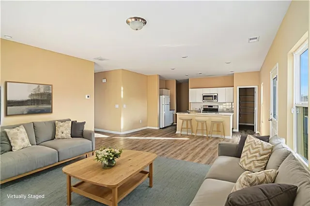 a living room with furniture kitchen and a table