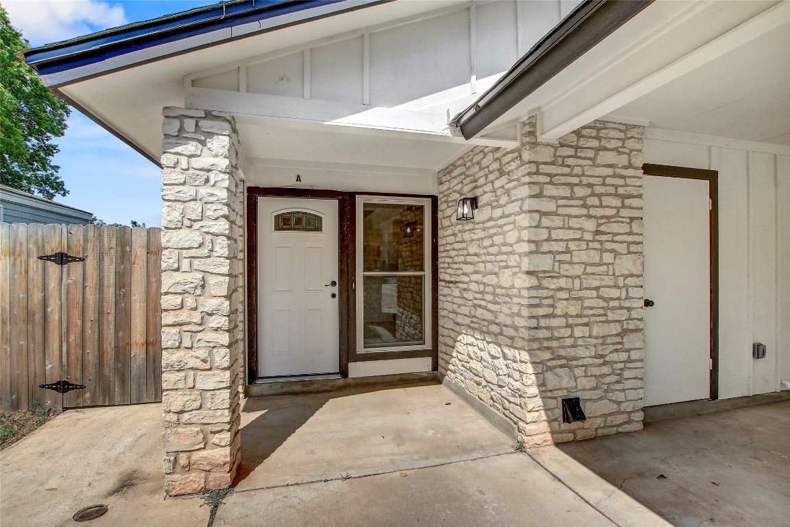 902 King Albert Street, Unit A Austin, TX 78745 - Photo 2 of 19 Doorway to property with stone siding and board and batten siding