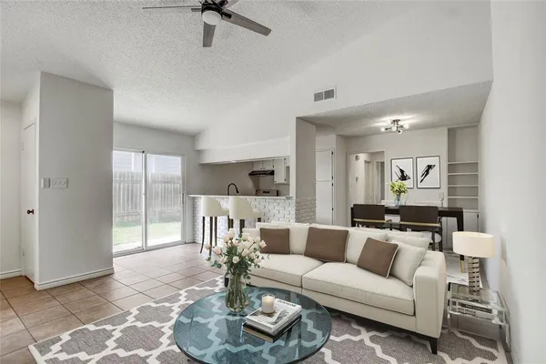 a living room with furniture and a glass door