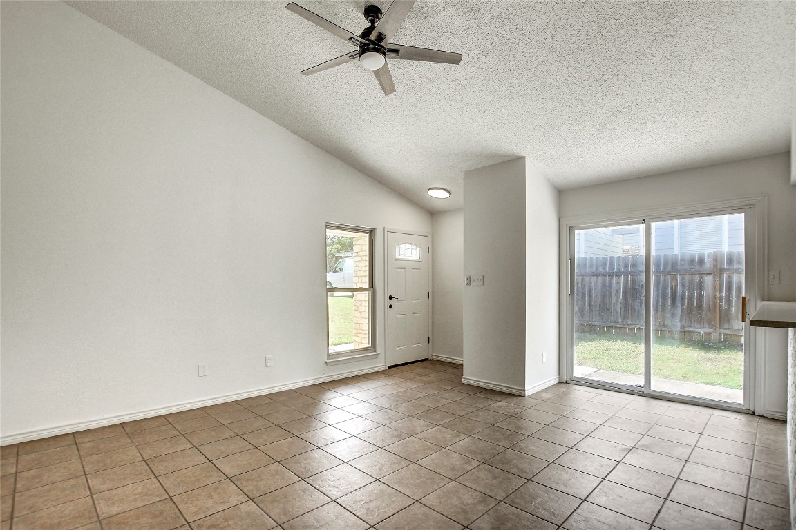 902 King Albert Street, Unit A Austin, TX 78745 - Photo 5 of 19 Foyer with light tile patterned flooring, a textured ceiling, plenty of natural light, lofted ceiling, and a ceiling fan