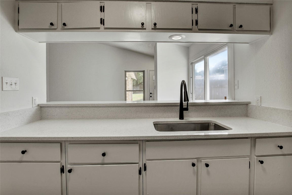902 King Albert Street, Unit A Austin, TX 78745 - Photo 10 of 19 Kitchen with light stone counters and white cabinetry