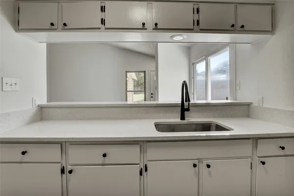a kitchen with a sink and cabinets