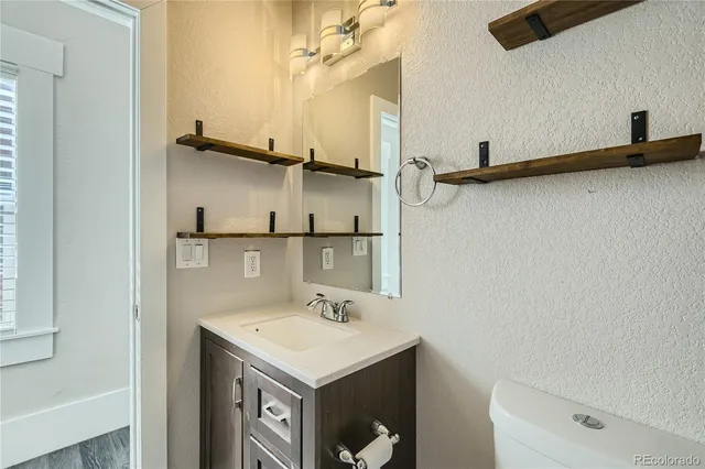 a bathroom with a sink a mirror and a toilet