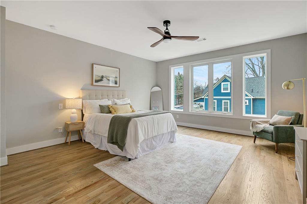 454 Connally Street Southeast Atlanta, GA 30312 - Photo 12 of 32 a bedroom with a large bed and a large window