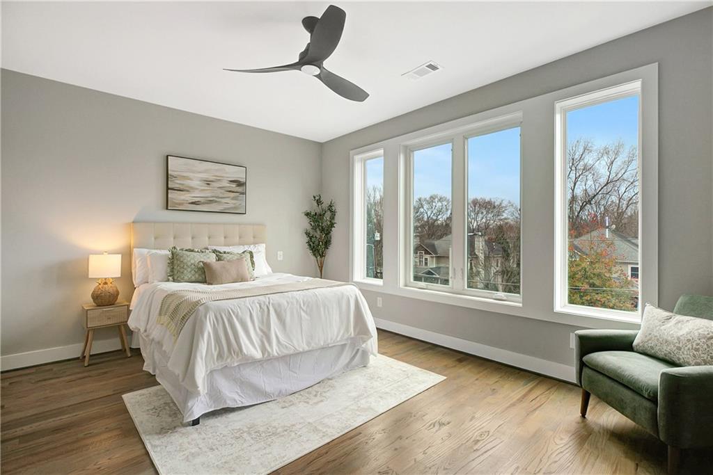 454 Connally Street Southeast Atlanta, GA 30312 - Photo 21 of 32 a bedroom with a bed couches and wooden floor