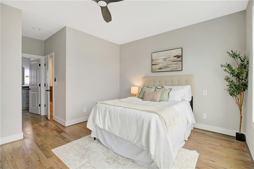 454 Connally Street Southeast Atlanta, GA 30312 - Photo 22 of 32 a bedroom with a bed and a potted plant on table