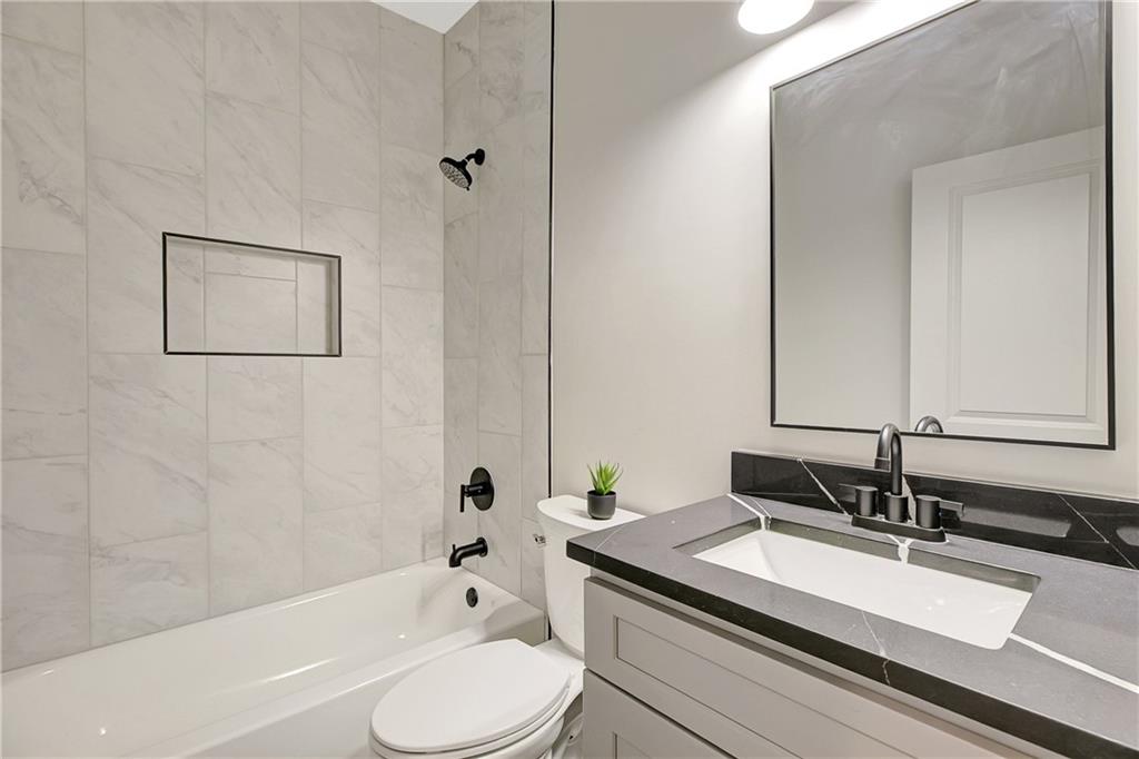454 Connally Street Southeast Atlanta, GA 30312 - Photo 27 of 32 a bathroom with a granite countertop sink mirror toilet and bathtub