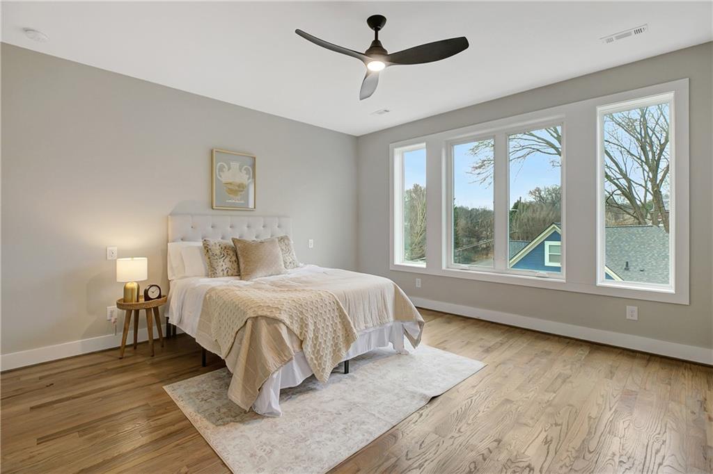 454 Connally Street Southeast Atlanta, GA 30312 - Photo 28 of 32 a bedroom with a large bed and a large window